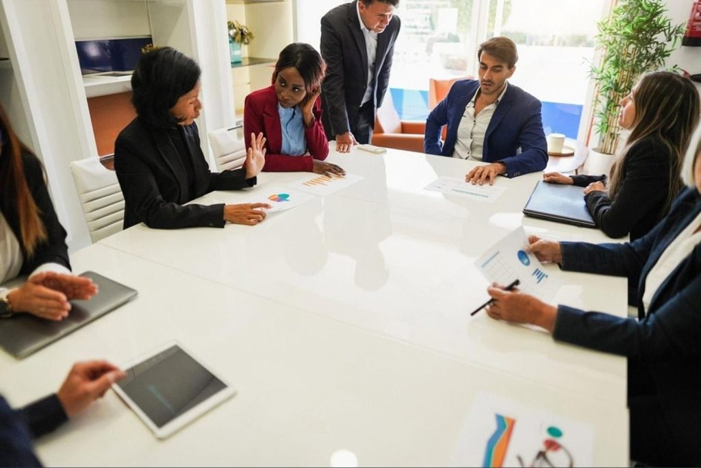 Executives around a boardroom table discussing third-party risk management reports